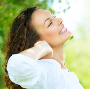 beautiful smiling brunette woman peeking around the corner